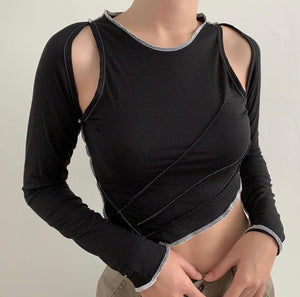 Black fabric top with white raw hem thread. Sewn on sleeves with some skin still exposed