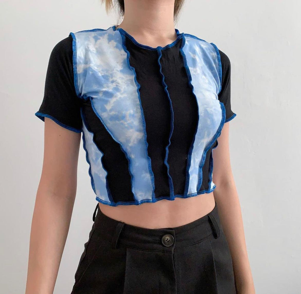 Middle black strips of fabric pieced together with a bleached blue strips of fabric. Stitched together with dark blue thread, raw hem