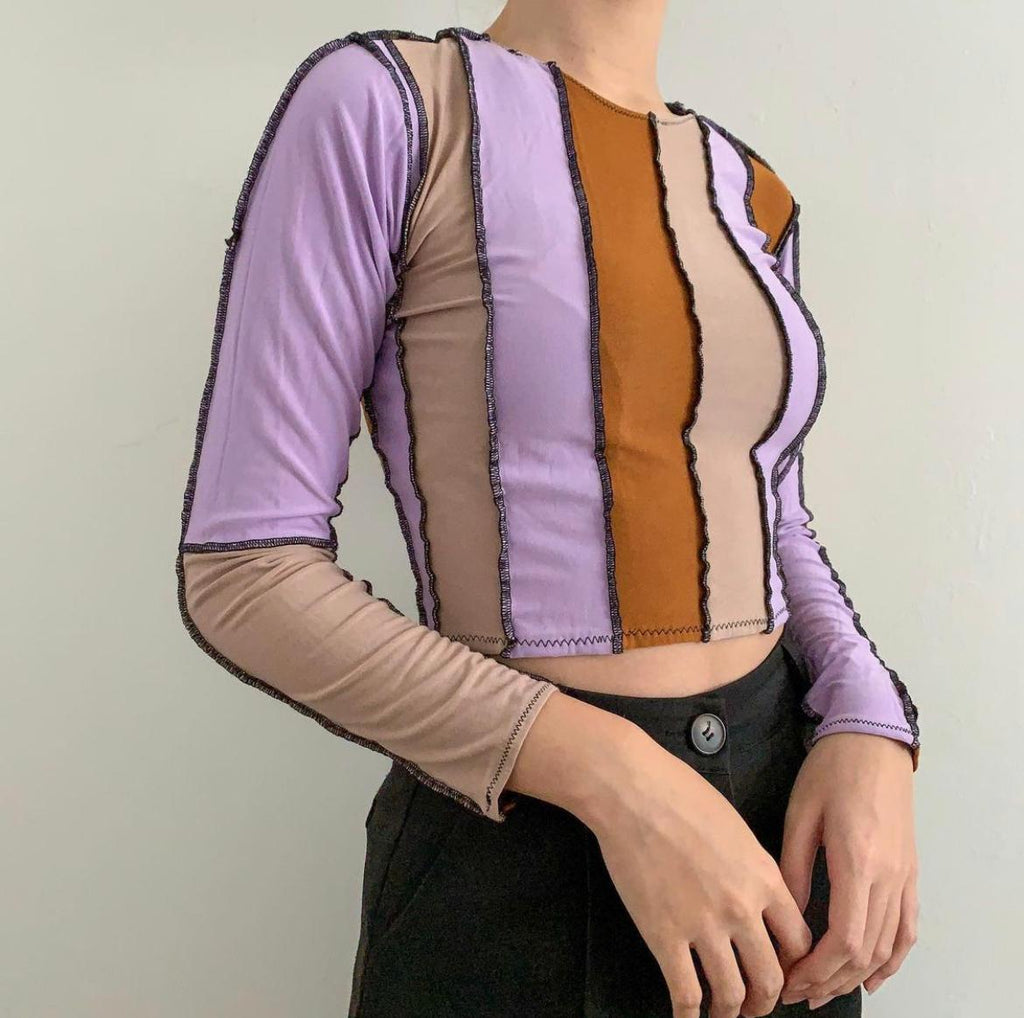 Strips of purple, orange and cream stitched together with black thread,raw hem long sleeve