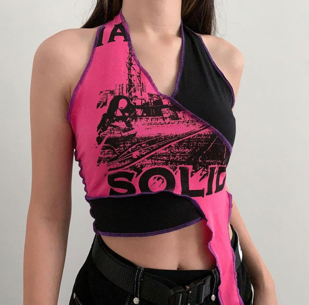 Bright pink deconstructed graphic top stitched together with black fabric with purple thread, raw hem