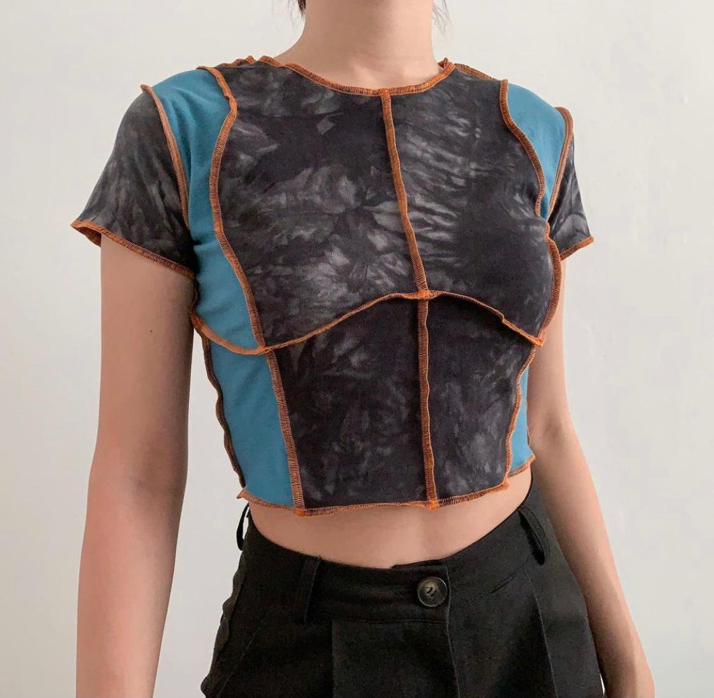 acid washed top stitched together with a turquoise blue patch fabric, with orange thread