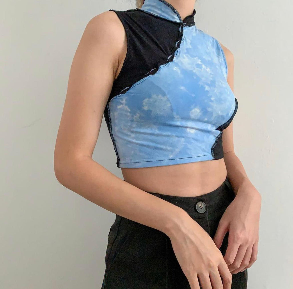 Sleeveless cheongsam cut top using bleached blue and black fabric. Raw hem using black thread.